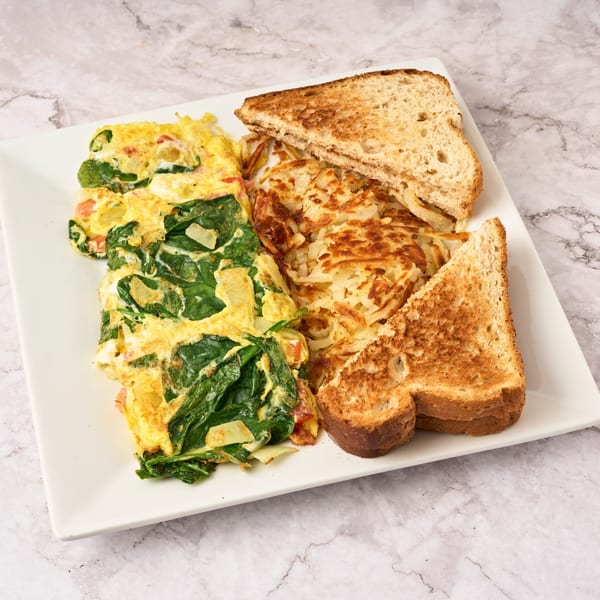 Watertown Cafe's breakfast plate with a spinach omelet, crispy hash browns, and two slices of toast.